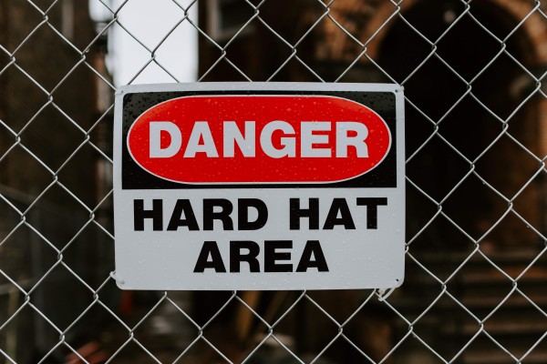 Danger, hard hat sign. Identifying project risk in capital project portfolios. 